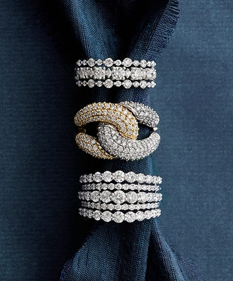 Blue Nile diamond rings on blue fabric